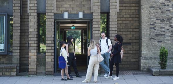 Students chatting outside Darwin College in Cambridge